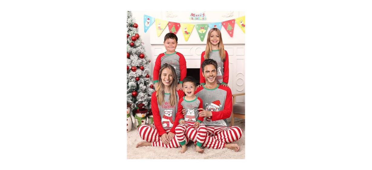 a family wearing Christmas pajamas with a polar bear on the shirt and red and white striped pants a family wearing Christmas pajamas with a polar bear on the shirt and red and white striped pants