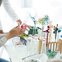 a woman arranging artificial plants