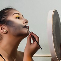 a woman applying makeup